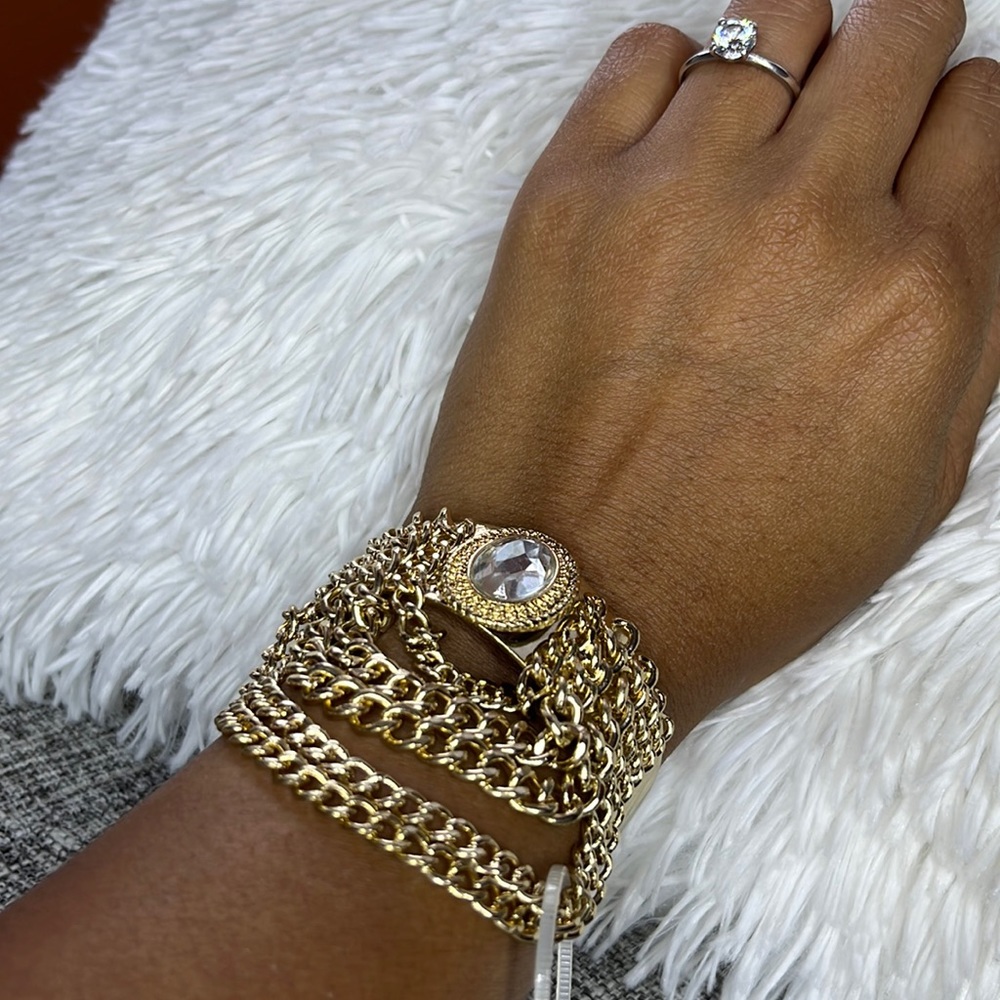 Gold cuff bracelet with chain tassels